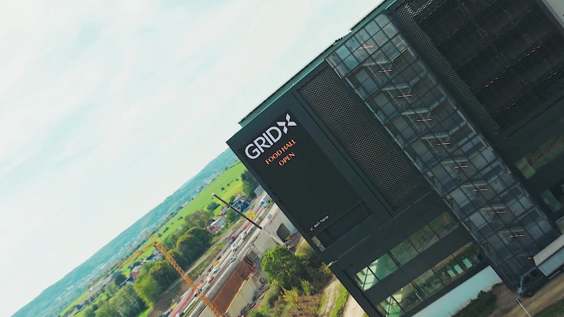 Oblique view of the GRIDX façade, signage and glazed structure.